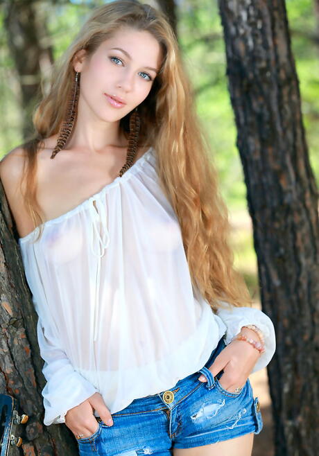 Shapely blonde teen Genevieve Gandi in shorts exposes small tits and shaved pussy outdoor