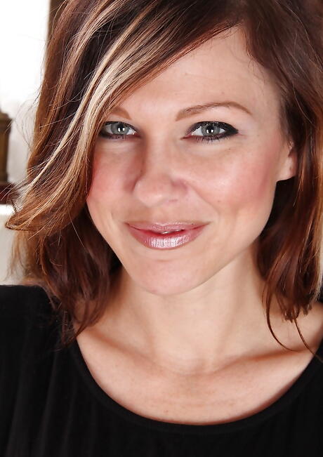 Foxy british milf Amy Johnson uncovering small tits and spreading her legs 